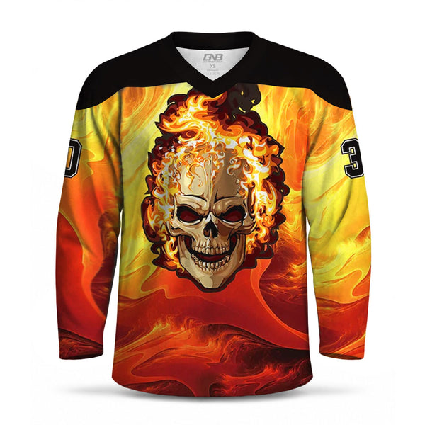 A long-sleeve V-neck hockey jersey with a black shoulder yoke and a vivid graphic print of a skull with flames on the front, set against a yellow and orange flame pattern. The jersey has black numbers on the sleeves.