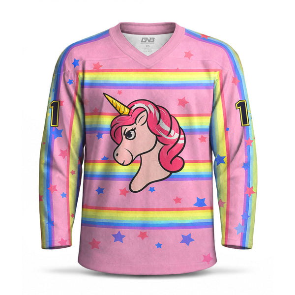 A pink long-sleeve V-neck hockey jersey with a cartoon unicorn graphic on the chest, rainbow horizontal stripes across the torso, blue star accents, and the number 1 on both sleeves.