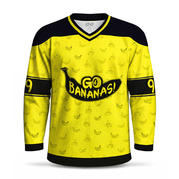 A long-sleeve hockey-style jersey in bright yellow with black shoulder panels, black sleeve stripes, and a large front graphic reading 'GO BANANAS!' inside a banana shape. The jersey is covered in small black banana illustrations, and personalized number appears on both sleeves.