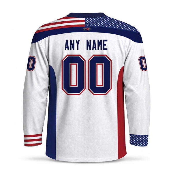 Customizable white hockey-style jersey shown from the back, featuring navy and red stripes, an American flag pattern on the shoulders, large personalized name and number, and patriotic red, white, and blue color blocking.
