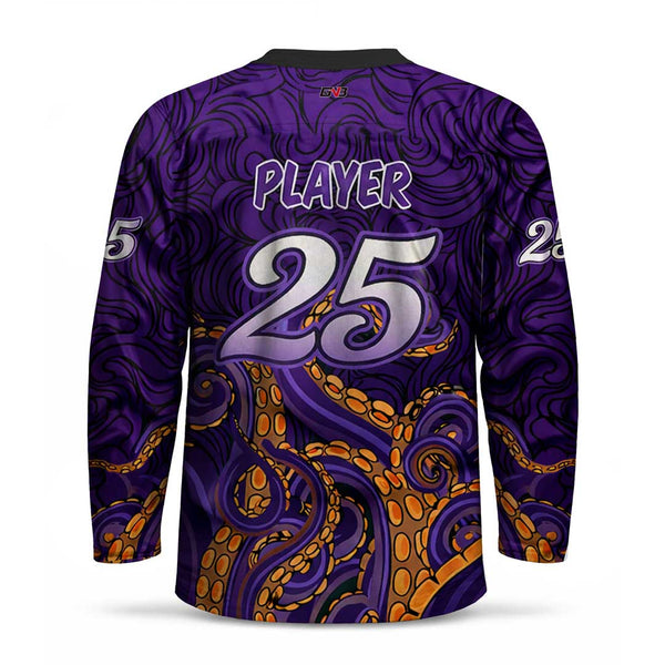 A long-sleeve purple sports jersey shown from the back, featuring a swirling abstract pattern and large silver personalized name and number. The lower half has an orange tentacle-like design with circular suction cups.