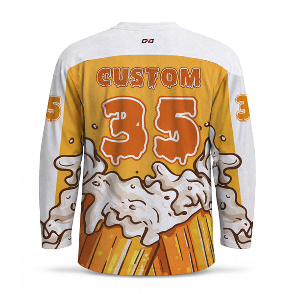 Custom long-sleeve hockey jersey shown from the back, featuring a white base with a large orange and yellow graphic print of a foaming beer mug, the number, and customized name.