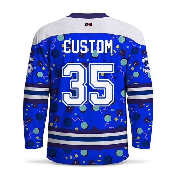 Custom hockey jersey back view with customized name and number in white, decorated with a colorful retro confetti pattern on a royal blue background.