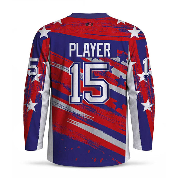 A long-sleeve sports jersey shown from the back, featuring a patriotic red, white, and blue design with stars, diagonal brushstroke stripes, and personalized name and number.