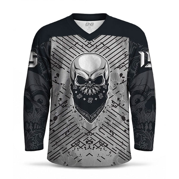 A long-sleeve V-neck hockey jersey with a black and gray graphic design. The center features a large metallic silver skull wearing a black bandana, surrounded by diagonal gray stripes and tribal-style patterns.