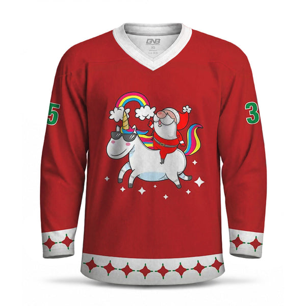 A red long-sleeve hockey jersey with a white V-neck collar, white cuff bands, and a central graphic of a white unicorn with a rainbow horn and Santa riding it. Green numbers appear on the sleeves, and a red-and-white patterned band decorates the lower hem.