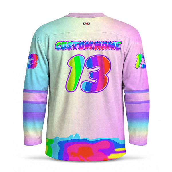 A long-sleeve hockey jersey shown from the back on a white background, featuring a pastel rainbow tie-dye gradient and a large multicolor neon-style number with personalized name above it.