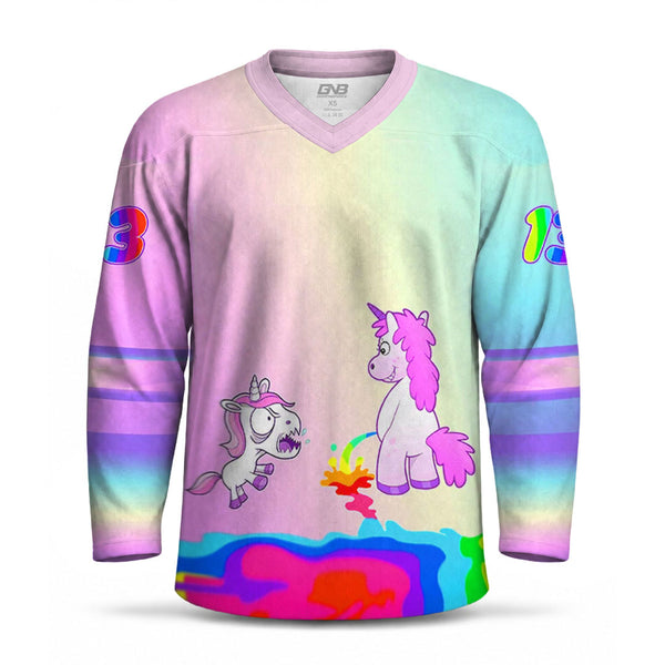 A long-sleeve V-neck hockey jersey with a pastel rainbow gradient background and cartoon unicorns printed on the front. The jersey features colorful sleeve stripes, multicolor number graphics on the shoulders, and a vibrant psychedelic lower hem.