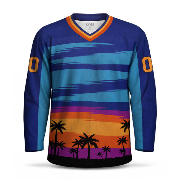 A long-sleeve V-neck hockey jersey with a colorful sunset and palm tree graphic. The top portion features horizontal stripes in shades of blue, purple, and teal, while the bottom section displays a sunset gradient in orange, purple, and black with black palm tree silhouettes.