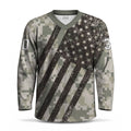 A long-sleeve V-neck hockey jersey with a distressed American flag design overlaid on a digital camouflage pattern. 